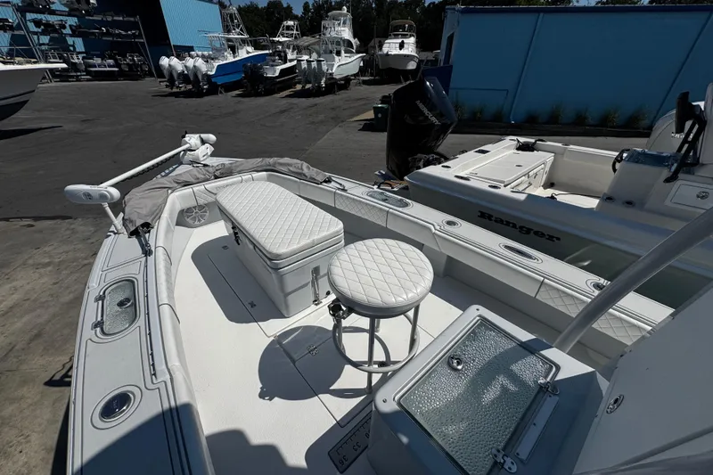 Slide: The Image of 2019 Dorado 25 Flat Deck boat with cushioned seating and fishing equipment. - 12