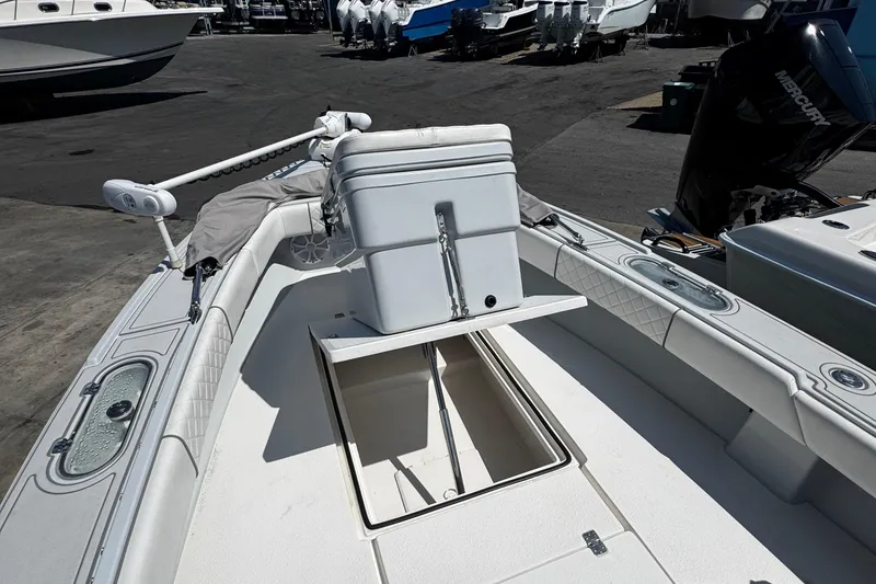 Slide: The Image of 2019 Dorado 25 Flat Deck boat with open storage compartment and motor. - 13