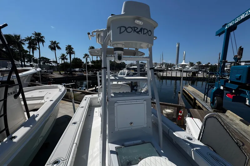 Slide: The Image of 2019 Dorado 25 Flat Deck boat docked at marina with palm trees and clear sky. - 15