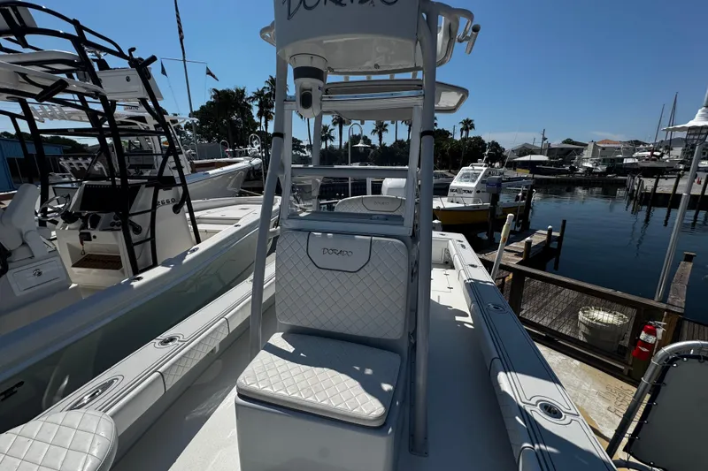 Slide: The Image of 2019 Dorado 25 Flat Deck boat docked at marina, featuring sleek design and comfortable seating. - 16