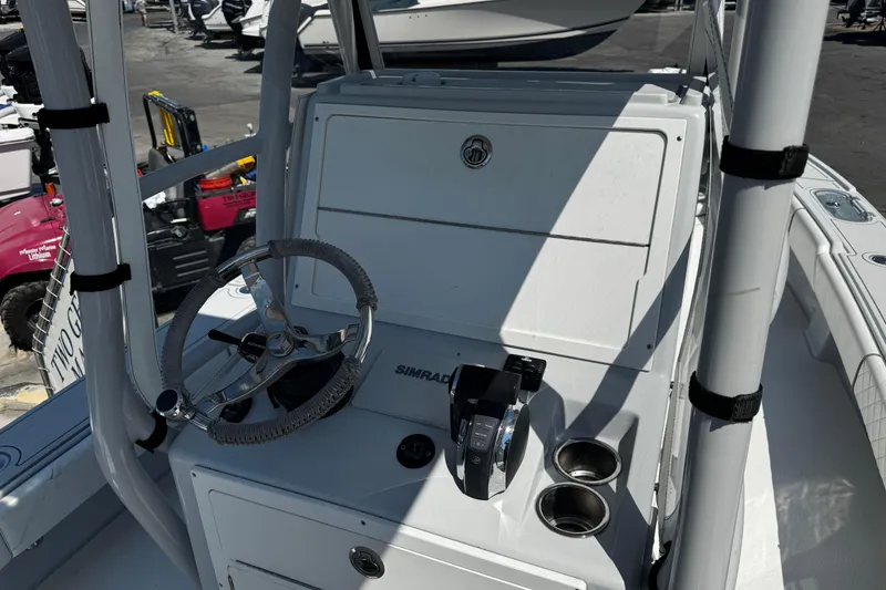 Slide: The Image of 2019 Dorado 25 Flat Deck boat console with steering wheel and controls. - 19