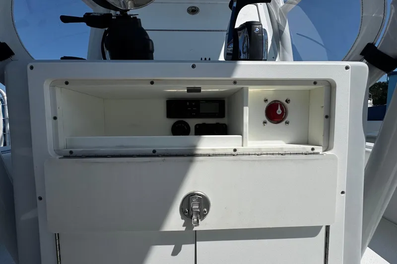Slide: The Image of 2019 Dorado 25 Flat Deck boat console with storage compartment and control panel. - 20