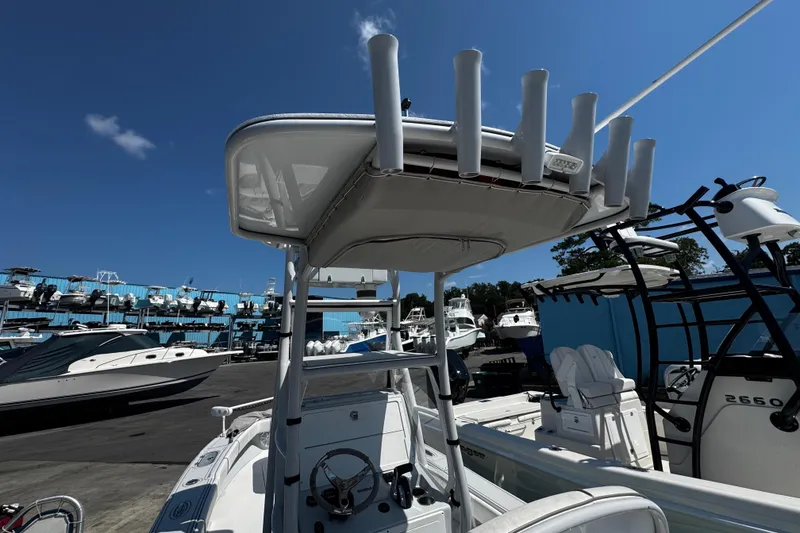 Slide: The Image of 2019 Dorado 25 Flat Deck boat in marina, clear sky, multiple boats in background. - 27