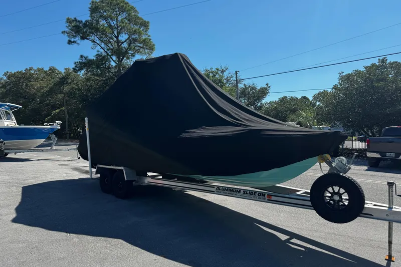 Slide: The Image of 2019 Dorado 25 Flat Deck boat covered on trailer in outdoor setting. - 32