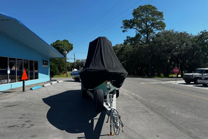 Slide: The Image of Covered 2019 Dorado 25 Flat Deck boat on trailer near blue building. - 33