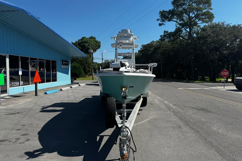 Slide: The Image of 2019 Dorado 25 Flat Deck boat on trailer outside a blue building. - 5