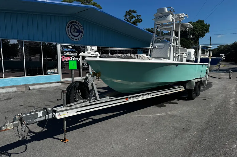 Slide: The Image of 2019 Dorado 25 Flat Deck boat on trailer outside a marine dealership. - 6