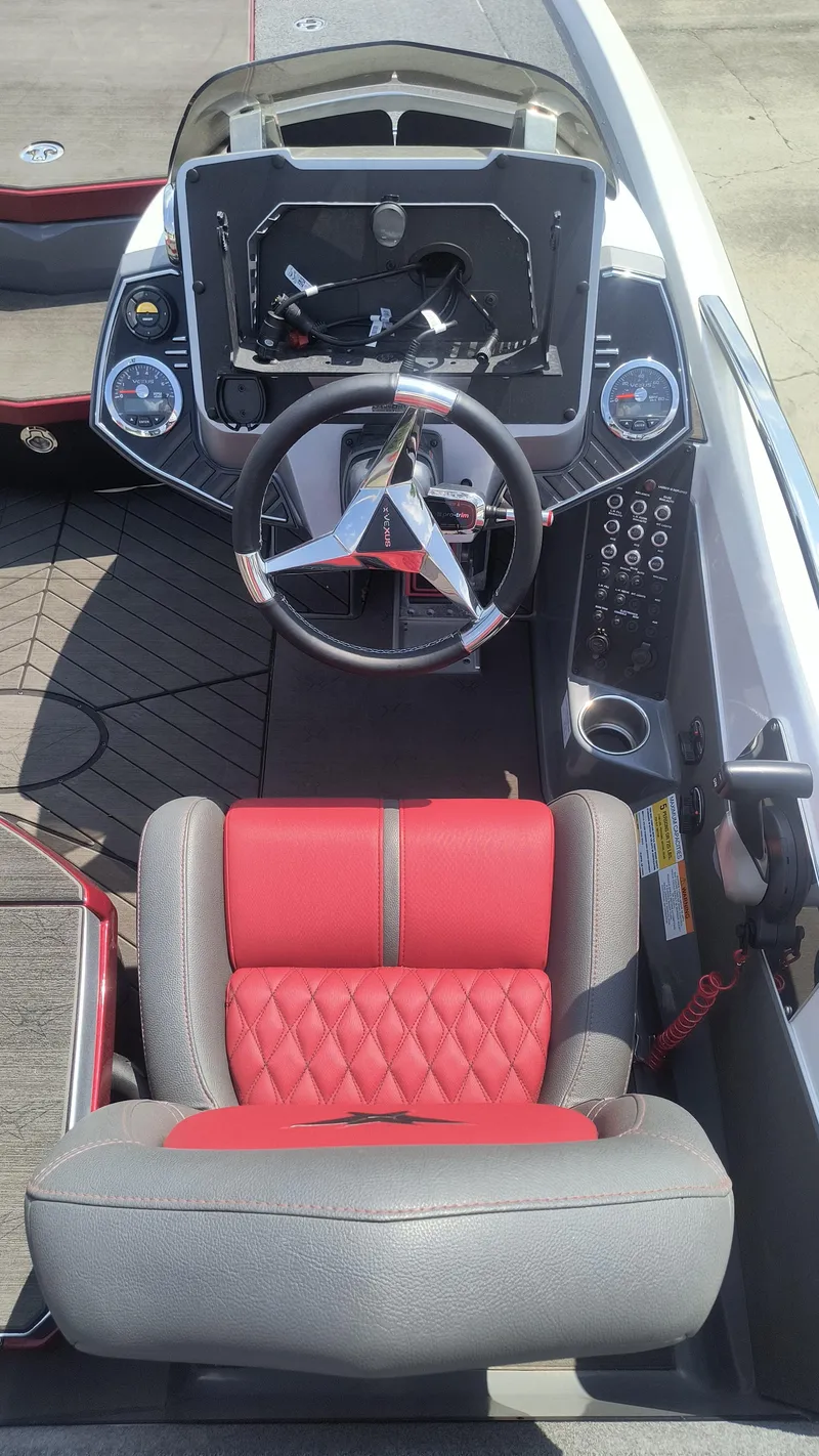 Slide: The Image of 2021 Vexus VX20 boat cockpit with red and gray seating, steering wheel, and control panel. - 12