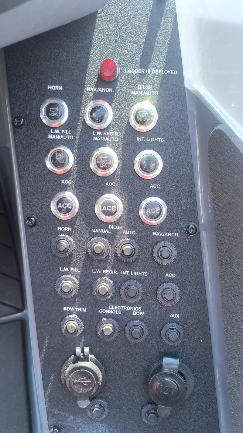 Slide: The Image of Control panel of a 2021 Vexus VX20 boat with various switches and indicators. - 7