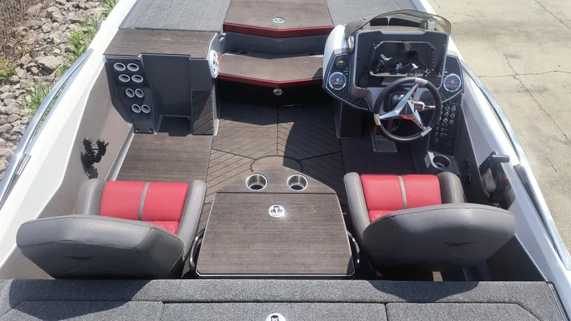 Slide: The Image of 2021 Vexus VX20 boat interior with red and gray seating, steering console, and storage compartments. - 9