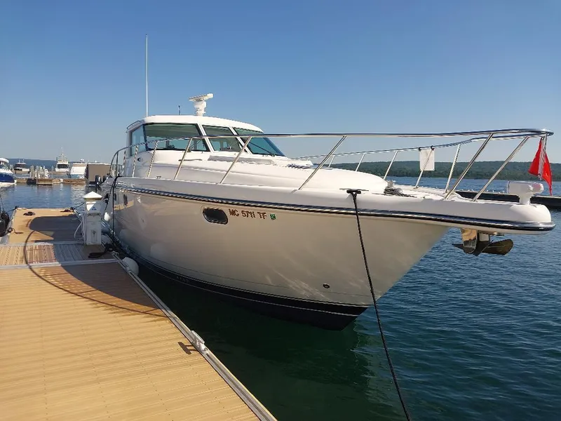 The Image of 2003 Tiara Yachts 4400 Sovran docked at marina on a sunny day. - 0