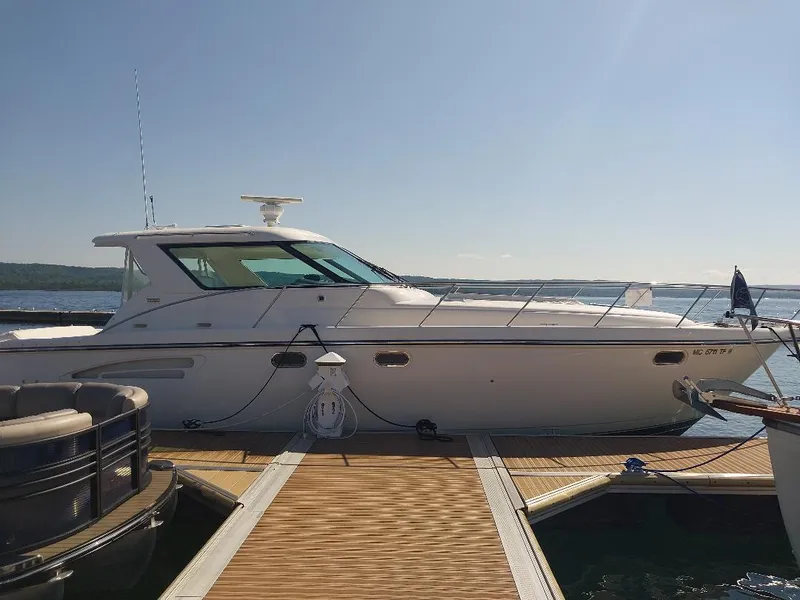 Slide: The Image of 2003 Tiara Yachts 4400 Sovran docked on a sunny day. - 1