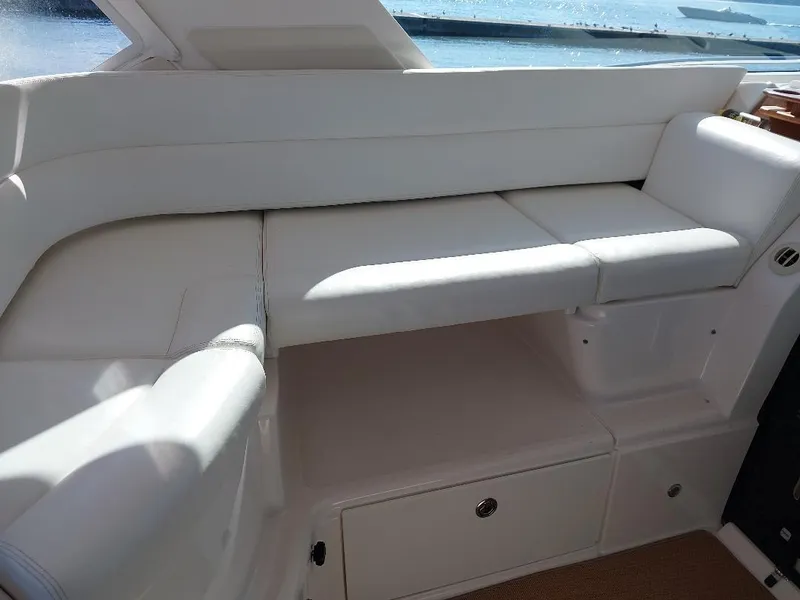 Slide: The Image of Luxurious white seating on 2003 Tiara Yachts 4400 Sovran, overlooking serene waters. - 10