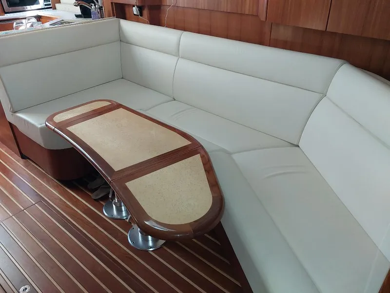 Slide: The Image of Luxurious interior of 2003 Tiara Yachts 4400 Sovran with elegant seating and wooden table. - 13