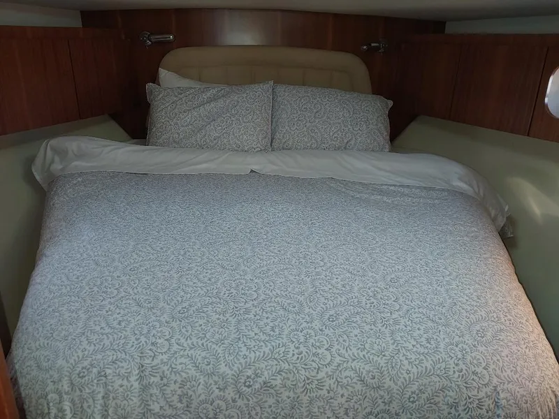 Slide: The Image of Cozy bedroom in 2003 Tiara Yachts 4400 Sovran with patterned bedding. - 16