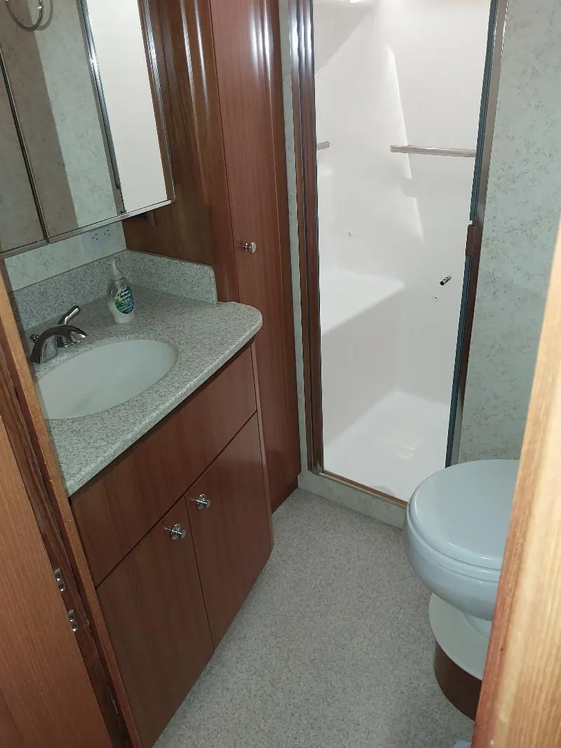 Slide: The Image of 2003 Tiara Yachts 4400 Sovran bathroom with sink, shower, and toilet. - 17