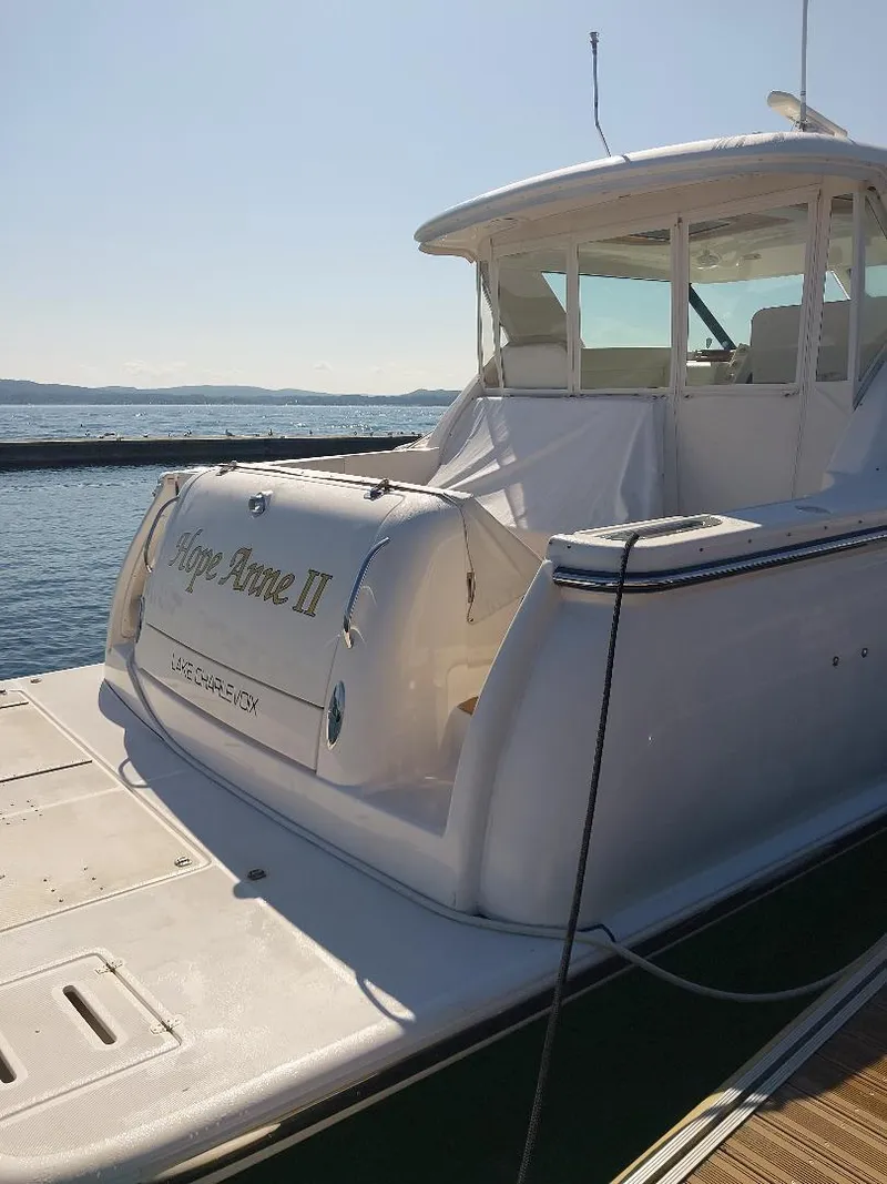 Slide: The Image of 2003 Tiara Yachts 4400 Sovran docked, rear view, sunny day, calm waters. - 3