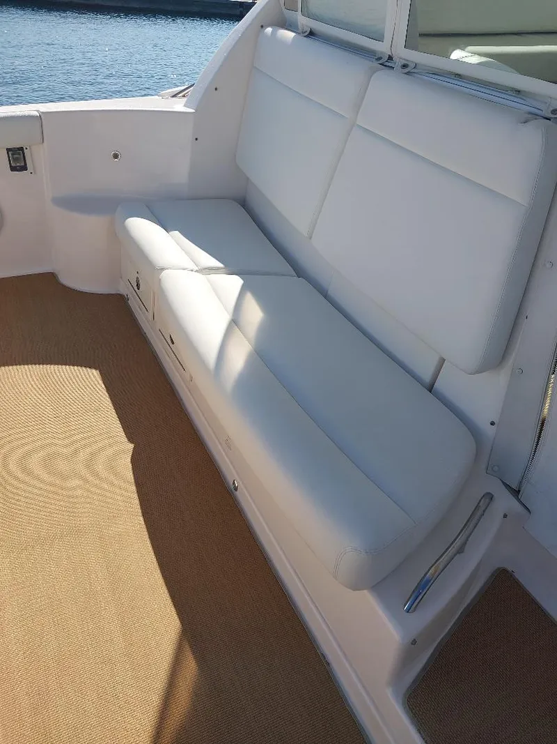 Slide: The Image of 2003 Tiara Yachts 4400 Sovran interior with white seating and beige flooring. - 5