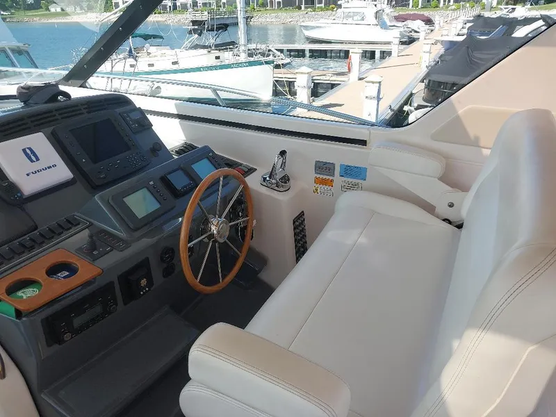Slide: The Image of 2003 Tiara Yachts 4400 Sovran helm with steering wheel and navigation equipment. - 8
