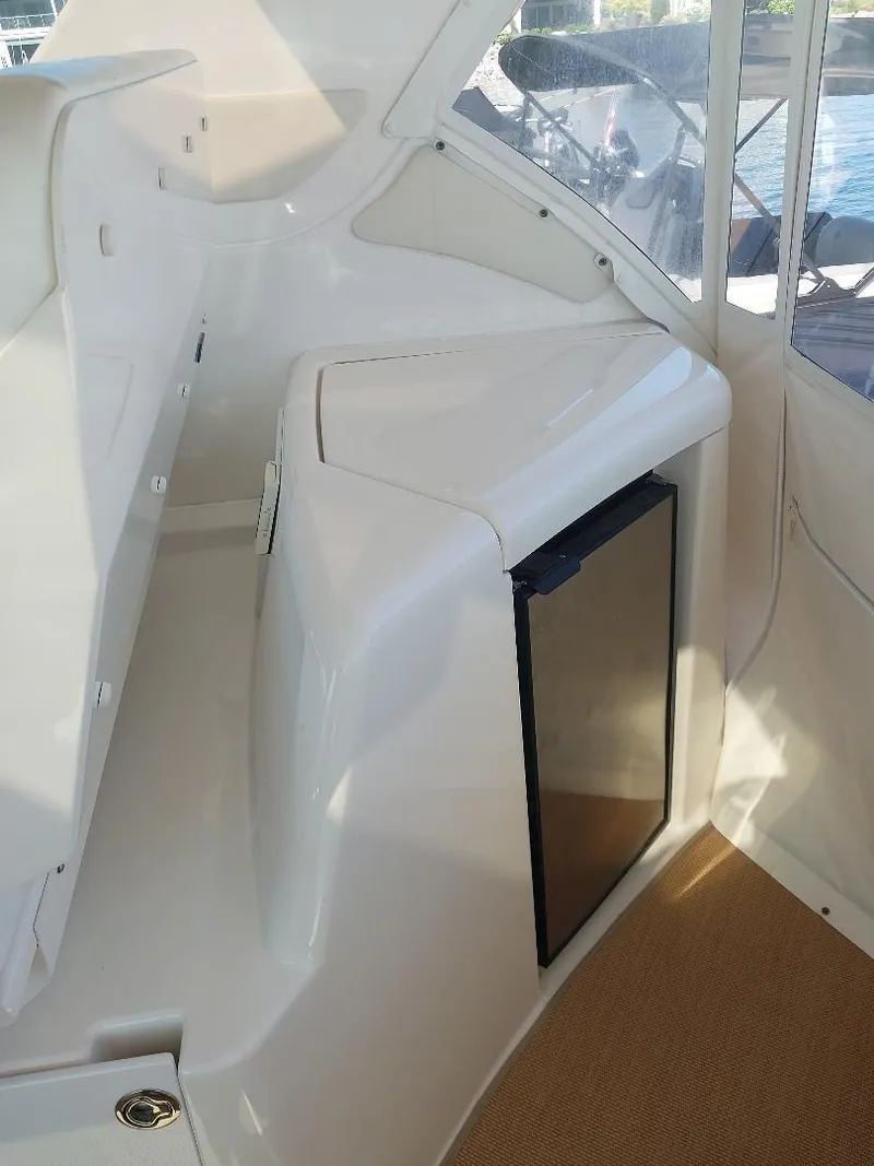 Slide: The Image of 2003 Tiara Yachts 4400 Sovran interior with compact fridge and sleek white design. - 9