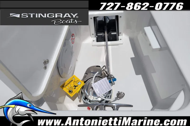 Slide: The Image of 2026 Stingray 253 CC boat anchor compartment with branding and contact details. - 10