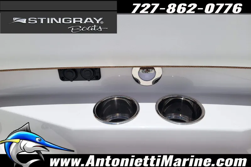 Slide: The Image of 2026 Stingray 253 CC boat detail with cup holders and logo, Antonietti Marine contact info. - 13