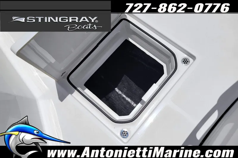 Slide: The Image of 2026 Stingray 253 CC boat hatch detail with contact information and logo. - 15