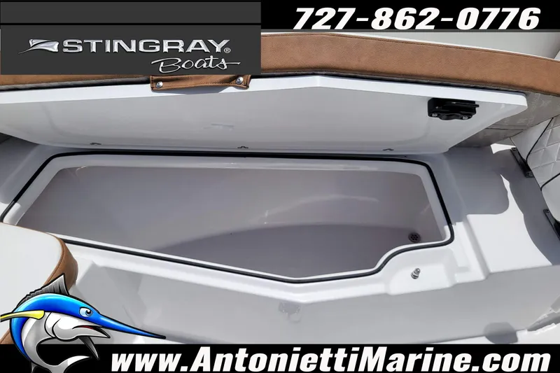 Slide: The Image of 2026 Stingray 253 CC boat storage compartment, open lid, displayed by Antonietti Marine. - 17