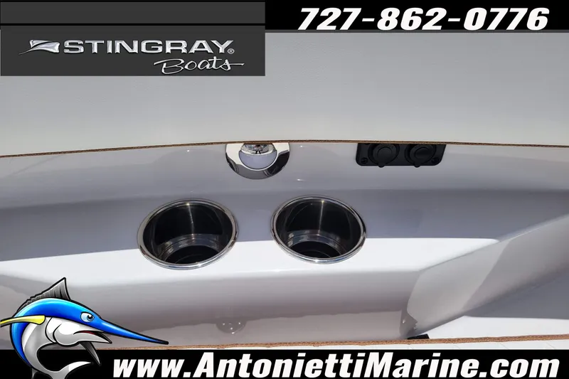 Slide: The Image of 2026 Stingray 253 CC boat detail with cup holders and contact information. - 18