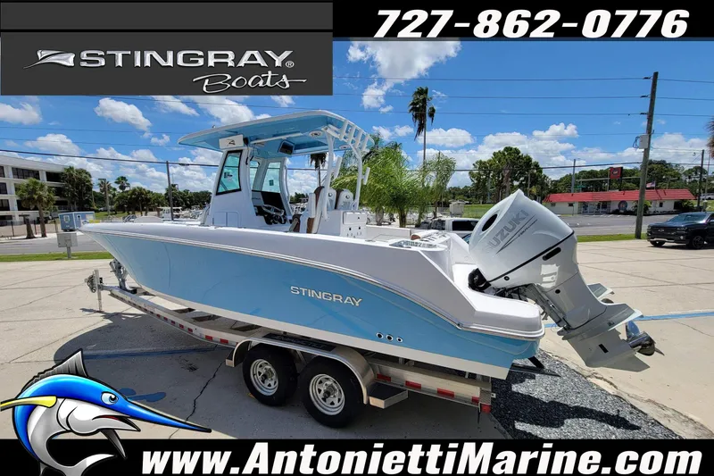 Slide: The Image of 2026 Stingray 253 CC boat on trailer at Antonietti Marine dealership. - 2