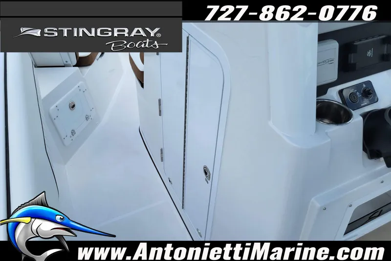 Slide: The Image of 2026 Stingray 253 CC boat interior with control panel and storage compartments. - 24