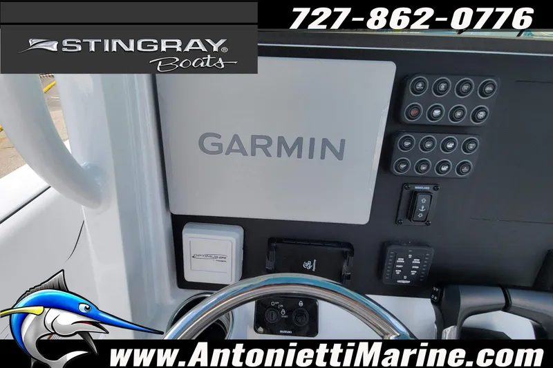 Slide: The Image of 2026 Stingray 253 CC boat dashboard with Garmin navigation system and control panel. - 32