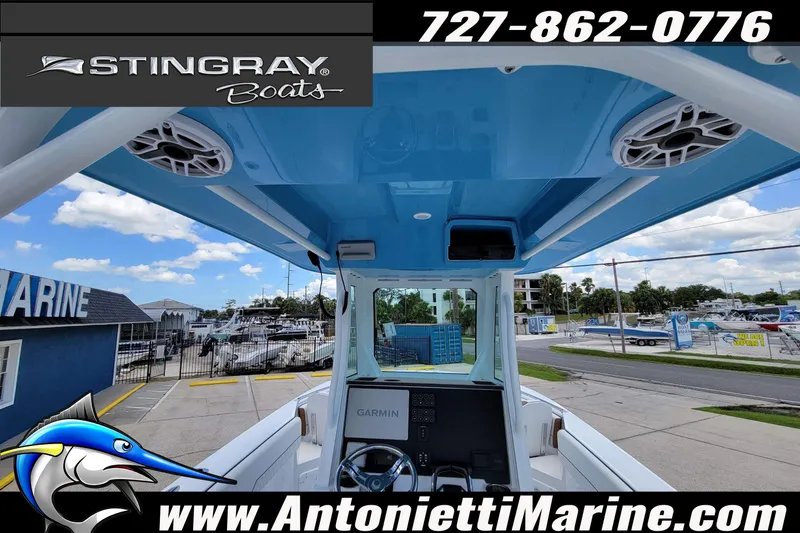 Slide: The Image of 2026 Stingray 253 CC boat interior with blue canopy, displayed at Antonietti Marine. - 33