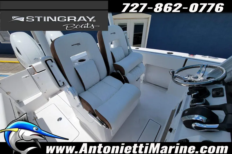 Slide: The Image of 2026 Stingray 253 CC boat interior with white seating and steering wheel, displayed by Antonietti Marine. - 38