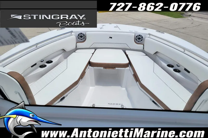 Slide: The Image of 2026 Stingray 253 CC boat interior with white seating and cup holders. - 4
