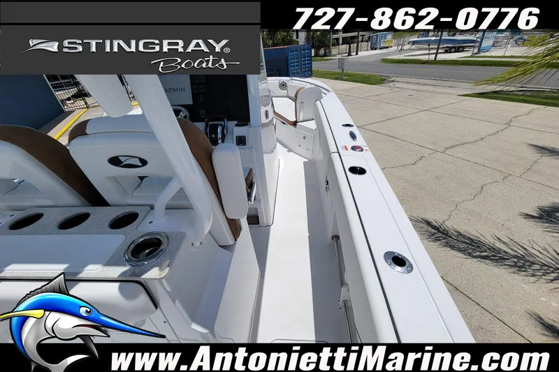 Slide: The Image of 2026 Stingray 253 CC boat interior with seating and console, displayed at Antonietti Marine. - 41