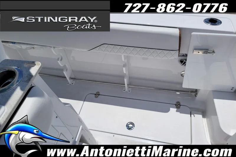 Slide: The Image of 2026 Stingray 253 CC boat interior with fishing rod holders and storage. - 45
