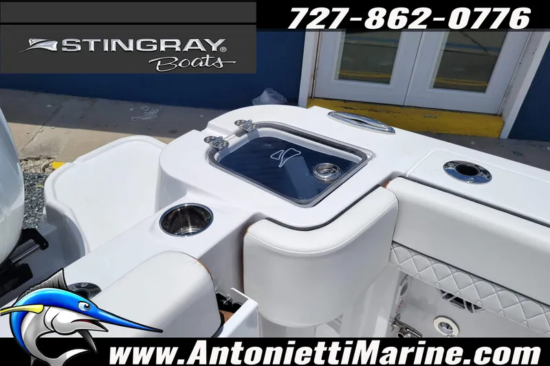 Slide: The Image of 2026 Stingray 253 CC boat interior with livewell and cup holders, showcased by Antonietti Marine. - 49