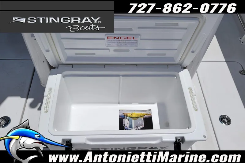 Slide: The Image of Open Engel cooler on 2026 Stingray 253 CC boat, featuring marine branding and contact details. - 55