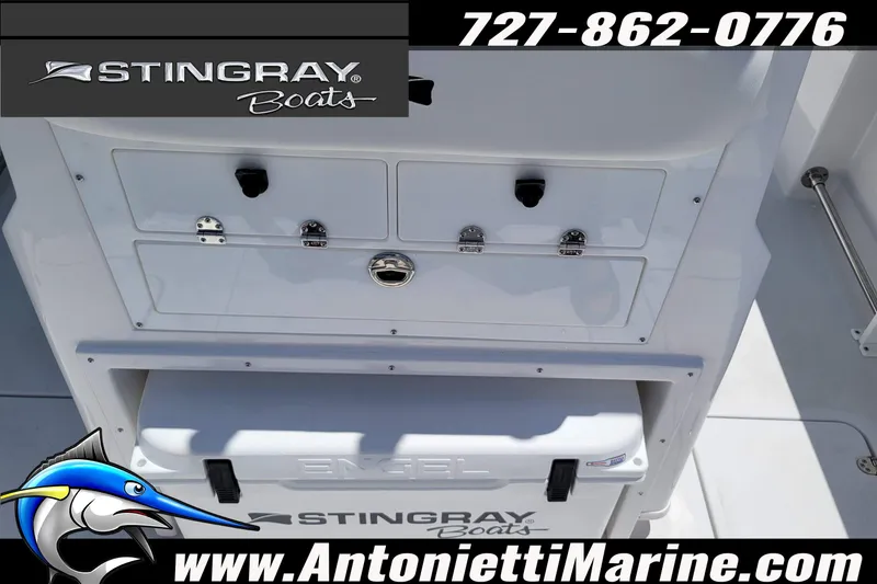 Slide: The Image of 2026 Stingray 253 CC boat interior with storage compartments and Engel cooler. - 57
