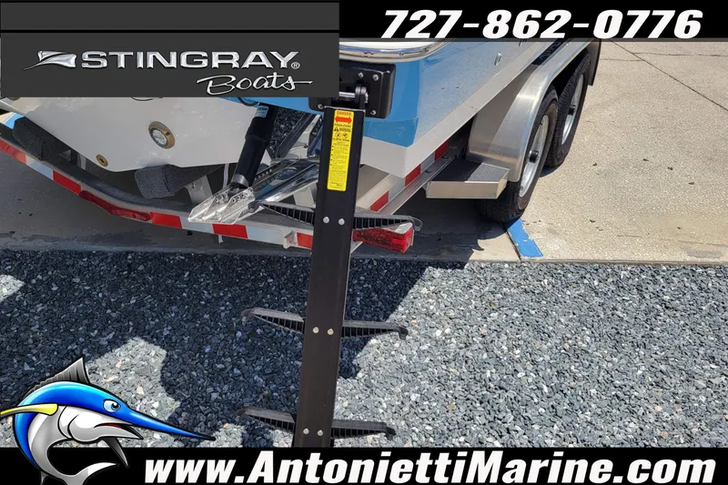 Slide: The Image of 2026 Stingray 253 CC boat on trailer at Antonietti Marine dealership. - 58