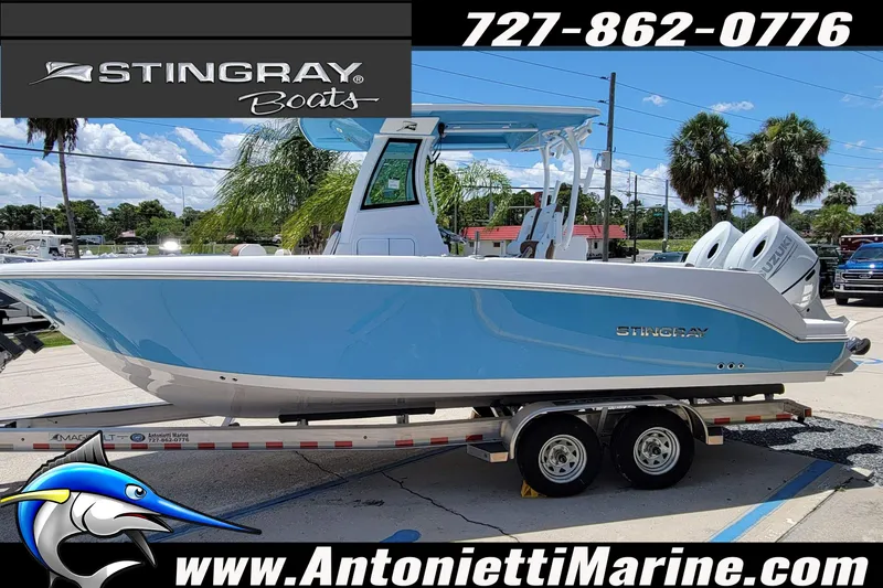 Slide: The Image of 2026 Stingray 253 CC boat in blue on trailer at Antonietti Marine dealership. - 64