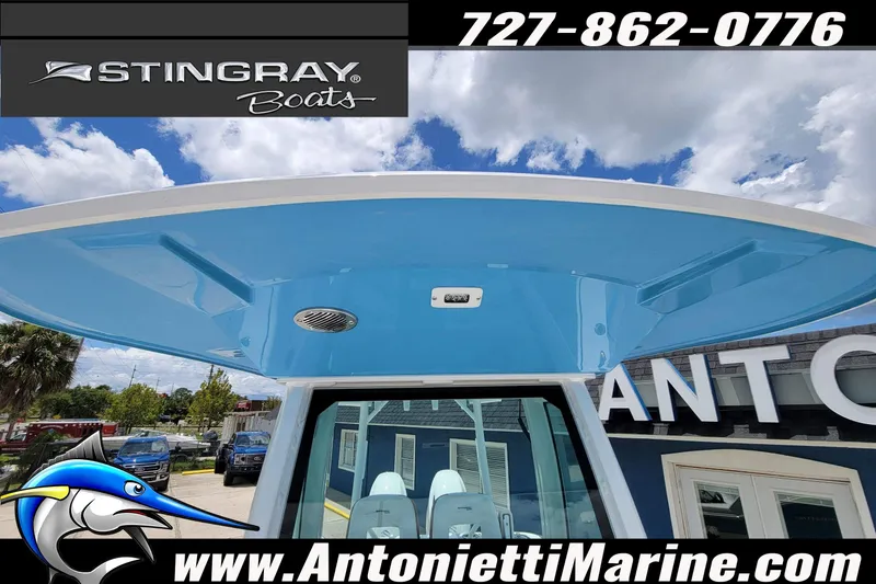 Slide: The Image of 2026 Stingray 253 CC boat at Antonietti Marine dealership under blue sky. - 8