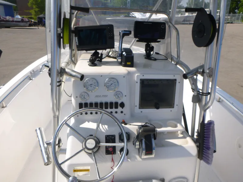 Slide: The Image of 2003 Sea Pro 220 Center Console boat dashboard with steering wheel and navigation equipment. - 10
