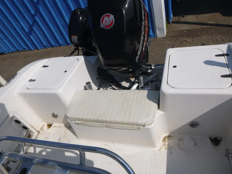 Slide: The Image of 2003 Sea Pro 220 Center Console boat with Mercury outboard motor, white seating, and storage compartments. - 11