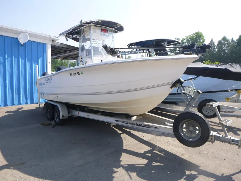 Slide: The Image of 2003 Sea Pro 220 Center Console boat on trailer near blue building. - 3