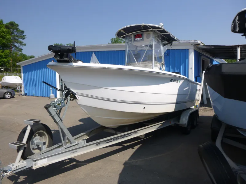 Slide: The Image of 2003 Sea Pro 220 Center Console boat on trailer, parked near blue building. - 4