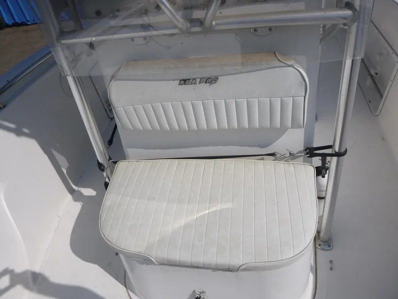 Slide: The Image of 2003 Sea Pro 220 Center Console boat seating with white upholstery and console details. - 7