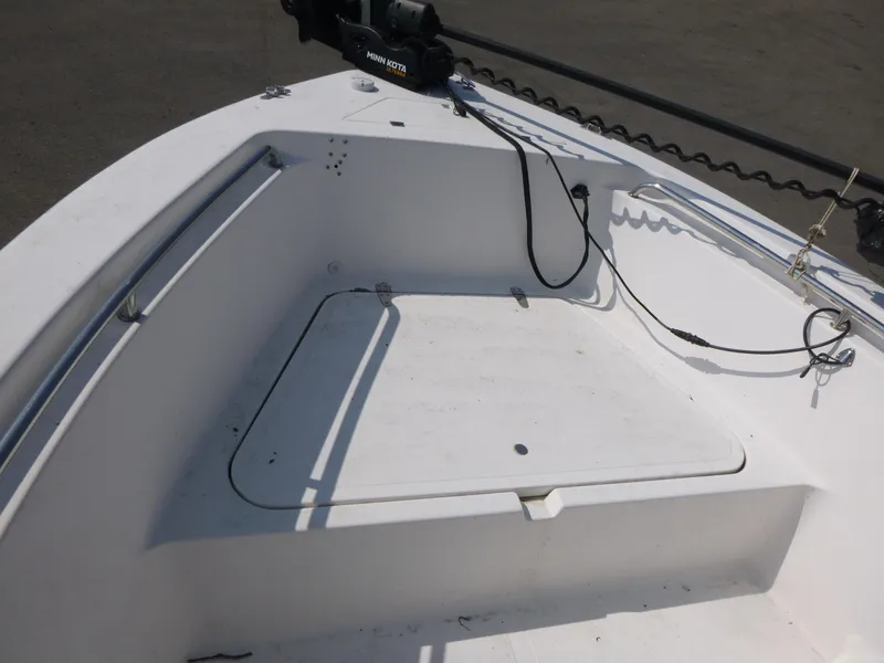 Slide: The Image of 2003 Sea Pro 220 Center Console boat deck with storage compartment and Minn Kota trolling motor. - 8