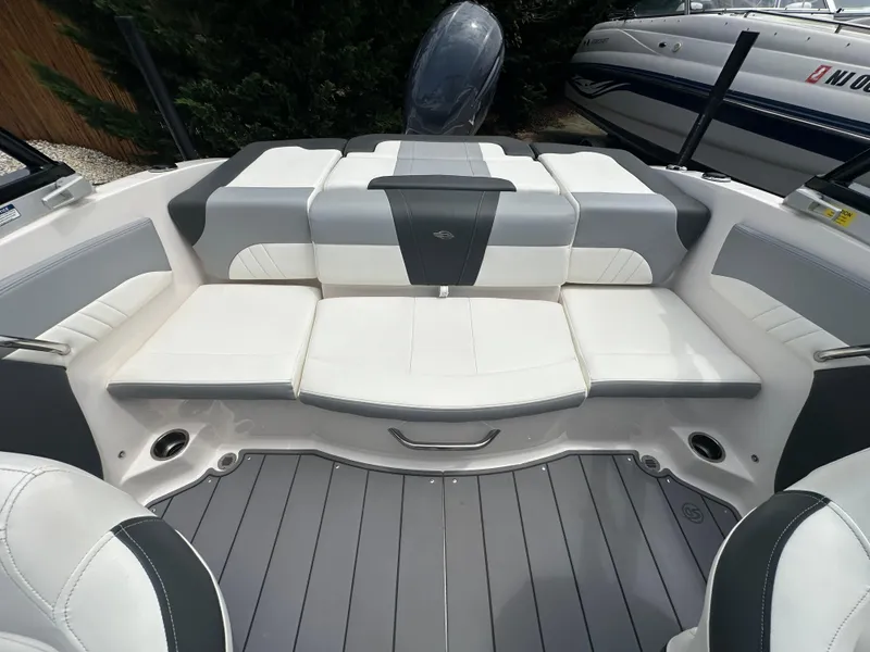 Slide: The Image of 2023 Chaparral 21 SSi OB boat interior with white and gray seating. - 10